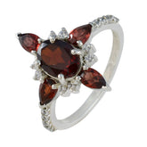 Carolina silver ring with oval center garnet and marquise accents and diamond halo red gemstone fashion ring